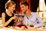 Beautiful_young_couple_with_glasses_of_red_wine.jpg